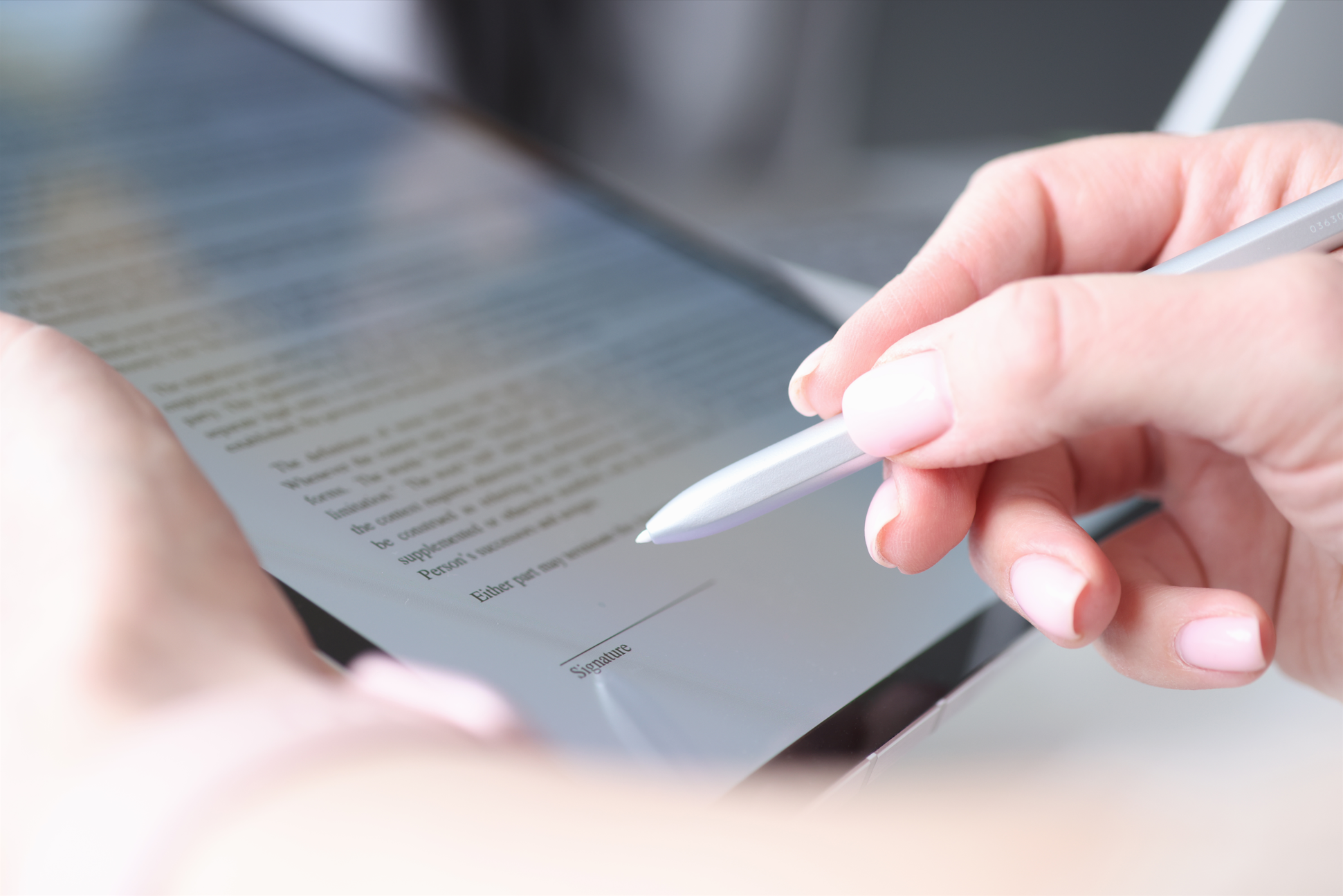 Guest signing a digital waiver on a tablet with stylus